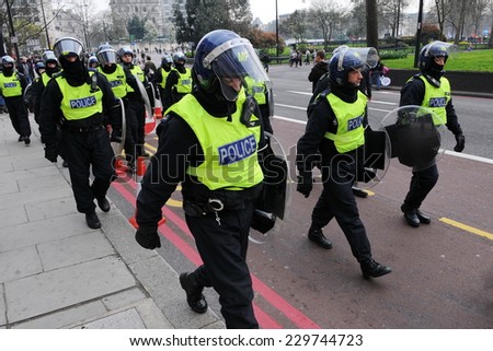 LONDON - MAR 26: Police in riot gear deploy on a city street after violent clashes with anti-cuts demonstrators on Mar 26, 2011 in London, UK. An estimated 250,000 rallied against government cuts.