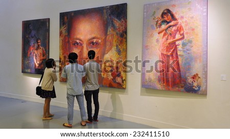 BANGKOK - FEB 22: People view art at an exhibition in Bangkok Art and Culture Centre (BACC) on Feb 22, 2012 in Bangkok, Thailand. Opened in 2008 the BACC showcases local and international artworks.