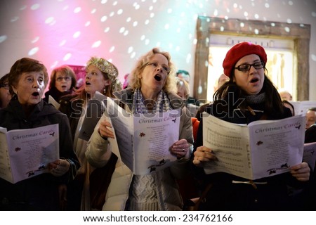 BATH - NOV 30: People sing carols at the Christmas Market in the streets surrounding Bath Abbey on Nov 30, 2014 in Bath, UK. The market is held annually in the historic Unesco World Heritage City.