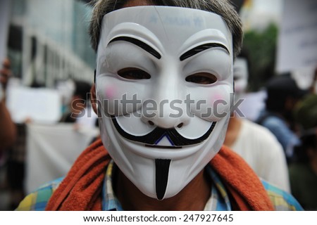 BANGKOK - JUN 2: Anti government protesters, many wearing Guy Fawkes masks, rally in a shopping district on Jun 2, 2013 in Bangkok, Thailand. The protesters call for the government to be overthrown.