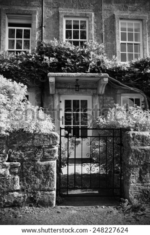 Exterior View of an Old English Cottage in Black and White