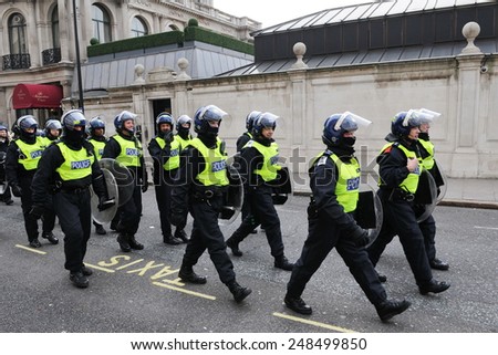 LONDON - MAR 26: Riot police deploy on a city centre street after violent riots break out during a 250,000 strong TUC organised anti public sector spending cuts rally on Mar 26, 2011 in London, UK.