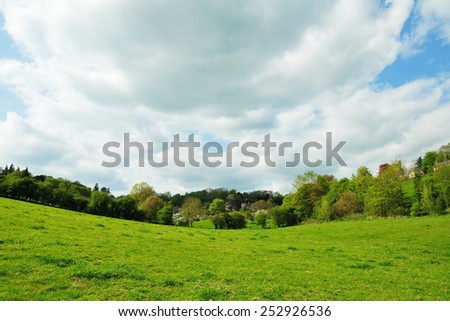 Scenic View of an Open Farmland Field with a Dramatic Cloudy Sky above in Wiltshire England