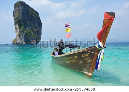 KOH PODA - JAN 20: View of a longtail boat in a calm seas on Jan 20, 2014 on Koh Poda, Thailand. Koh Poda is a popular tourist Island in the Andaman sea of the coast of Thailand\'s Krabi province.