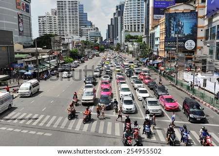 BANGKOK - JUN 1: Traffic waits at a busy junction in the city centre on Jun 1, 2014 in Bangkok, Thailand. Annually an estimated 150,000 new cars join the heavily congested roads of the Thai capital.