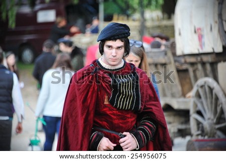 BRADFORD ON AVON - JULY 1: An unidentified actor walks through a during filming of Wolf Hall on July 1, 2014 in Bradford on Avon, UK. Wolf Hall is a period drama set in the 16th century.
