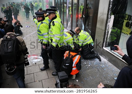 LONDON - MARCH 26: Police arrest a protester during a large anti austerity rally on March 26, 2011 in London, UK. Protesters clashed with police repeatedly with dozens of arrests.