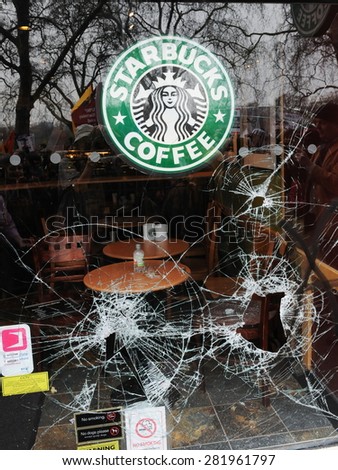 LONDON - MARCH 26: A Starbucks Coffee shop is vandalised as an anti austerity protesters rally in the British capital on Mar 26, 2011 in London, UK. Violent clashes broke out with a number of arrests.