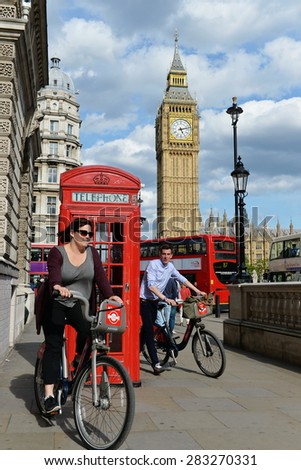 LONDON - MAY 30: Tourists ride bikes through Westminster past Big Ben and the Houses of Parliament on a sunny day on May 30, 2015 in London, UK. London had 17 million international visitors in 2013.
