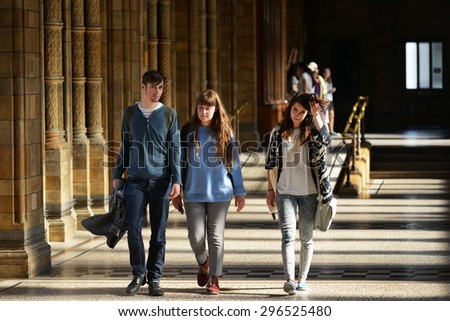 LONDON - JUN 16: People walk along a corridor in the Natural History Museum on Jun 16, 2015 in London, UK. Established in 1881 the museum houses 80 million items from around the world.
