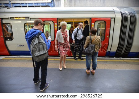 LONDON - JUN 16: People board and disembark a Victoria Line underground train on Jun 16, 2015 in London, UK. The London Underground carried a record 1.26 billion passengers in the year 2013-2014.