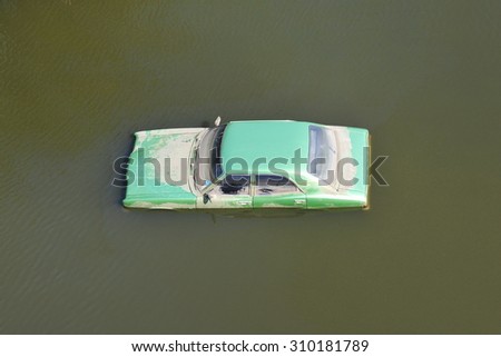 BANGKOK - NOV 18: A flooded car in a parking lot at Don Mueang International Airport, which is closed due to the severe flooding in the Thai capital on Nov 18, 2011 in Bangkok, Thailand.