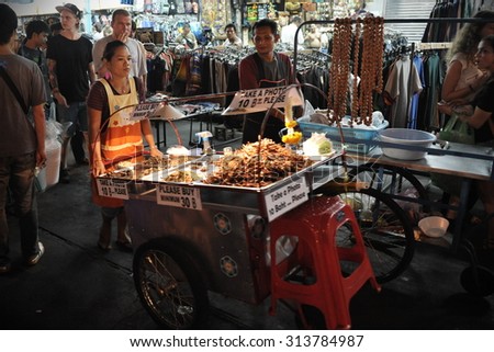 BANGKOK - MAR 29: A street vendor sells fried cockroaches and other insects on Khao San Road on Mar 23, 2012 in Bangkok, Thailand. There are an estimated 16,000 registered street vendors in Bangkok.