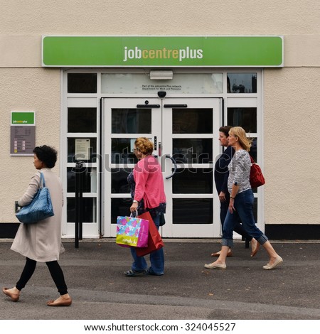 WELLS - AUG 30: People walk past a JobCentre Plus unemployment office in the city centre on Aug 30, 2014 in Wells, UK. The modern welfare state in the UK was founded on the Beveridge Report of 1942.
