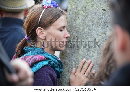 STONEHENGE - JUN 20: A reveller joins celebrations marking the Summer Solstice on Jun 20, 2014 in Stonehenge, UK. Thousands gathered at the ancient historic monument to celebrate the solstice.