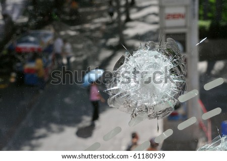 BANGKOK - MAY 23: Window of Zen Central World shopping mall damaged by gunfire and the scene of multiple killings during the anti government \'Red Shirt\' protest May 23, 2010 in Bangkok, Thailand.