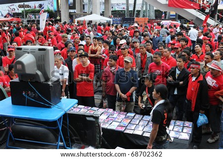 BANGKOK - JANUARY 9: Red Shirt protesters watch a video of a political speech at a 30,000 strong anti government rally at Rachaprasong junction on January 9, 2011 in Bangkok, Thailand.