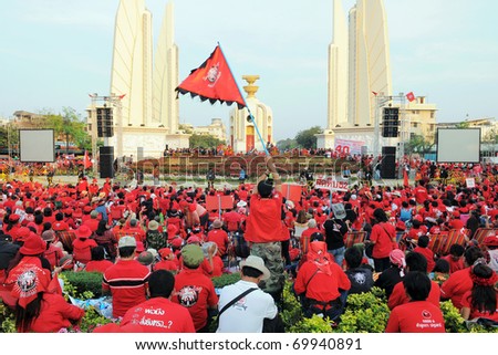 BANGKOK - JANUARY 23: Thousands of anti-government red-shirt protesters converge at Democracy Monument on January 23, 2011 in Bangkok, Thailand. The red-shirts are calling for political change.
