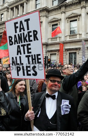 LONDON - MARCH 26: A protester dresses as a banker attends a large anti public sector spending cuts rally organised by the TUC March 26, 2011 in London, UK.