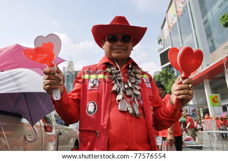BANGKOK - MAY 19: A Red Shirt protester attends a large rally at Ratchaprasong on May 19 2011 in Bangkok, Thailand. Protesters gathered to mark one year since 91 died in protests in the Thai capital.