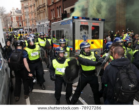 LONDON - MARCH 26: Riot police and protesters clash during a TUC organised anti-cuts rally March 26, 2011 in London, UK.