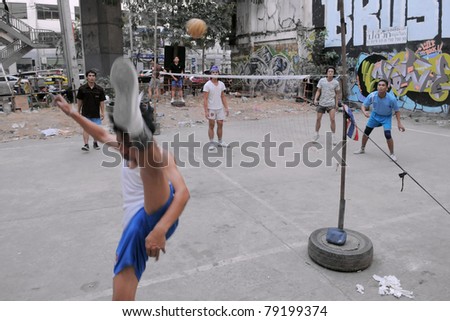 BANGKOK - JAN 20: Takraw players compete in a street match on derelict land on Jan 20, 2011 in Bangkok, Thailand. Takraw or sometimes Kick Volleyball is one of the national sports of Thailand.
