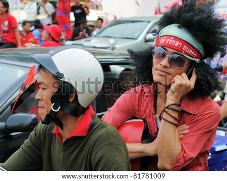 BANGKOK - JAN 23: Unidentified red-shirt protesters on a motorcycle during a large anti-government rally at Ratchaprsong on Jan 23, 2011 in Bangkok, Thailand.