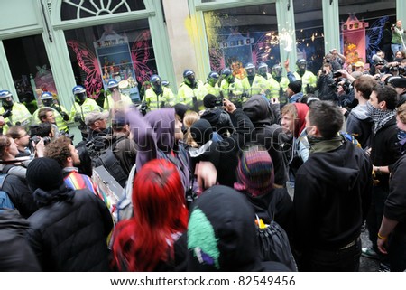 LONDON - MARCH 26: A breakaway group of anti-cuts protesters confront police and occupy Fortnum and Mason on Piccadilly during a large TUC organised rally on March 26, 2011 in London, UK.