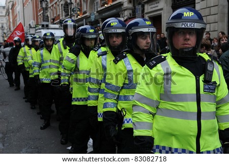 LONDON - MARCH 26: Police in riot gear on standby in central London during a large anti-cuts rally on March 26, 2011 in London, UK.