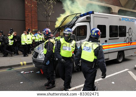 LONDON - MARCH 26: Riot police come under attack during a large anti-cuts rally on March 26, 2011 in London, UK.