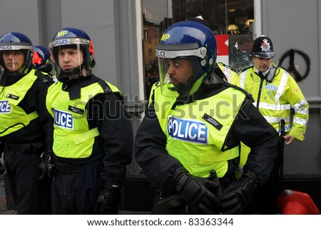 LONDON - MARCH 26: Police in riot gear on standby in central London during violent anti-cuts protests on March 26, 2011 in London, UK.