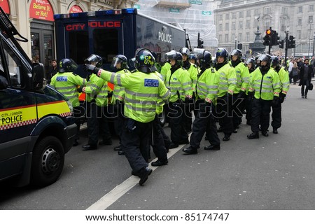 LONDON - MARCH 26: Police in riot gear at Picaddilly Circus in central London during a violent anti-cuts rally on March 26, 2011 in London, UK.