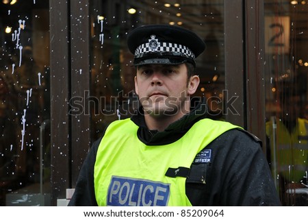 LONDON - MARCH 26: An unidentified policeman on duty in central London after having come under attack by a breakaway group of protesters during a large anti-cuts rally on March 26, 2011 in London, UK.