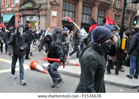 LONDON - MARCH 26: A breakaway group of protesters march through the streets of the British capital during a large anti-cuts rally on 26 March 2011 in London, UK.