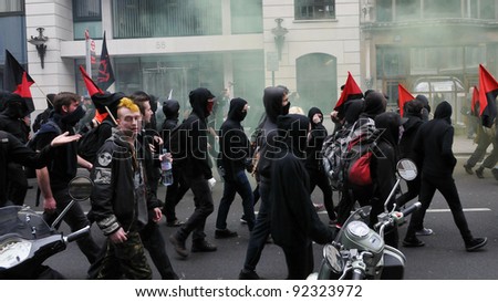 LONDON - MARCH 26: A breakaway group protesters march through the streets of the British capital during a large anti-cuts rally on March 26, 2011 in London, UK.