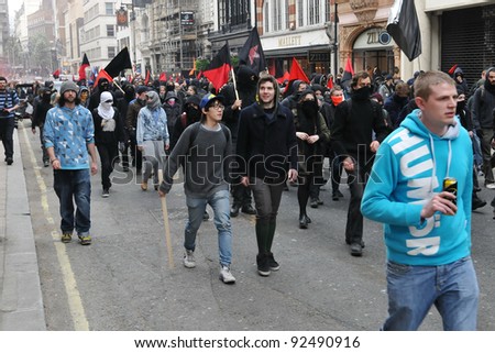 LONDON - MARCH 26: A breakaway group of protesters march through the streets of the British capital during a large austerity rally on 26 March 2011 in London, UK.