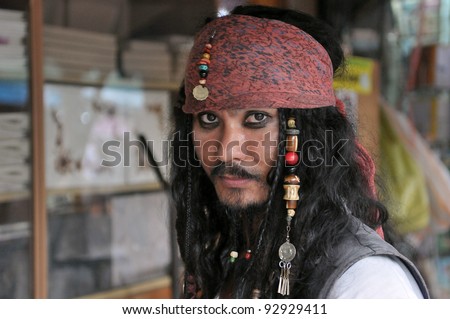 BANGKOK - SEPT 11: An unidentified man poses as Jack Sparrow from Pirates of the Caribbean movie franchise at an informal cosplay meet at Chatuchak Weekend Market Sept 11, 2011 in Bangkok, Thailand.