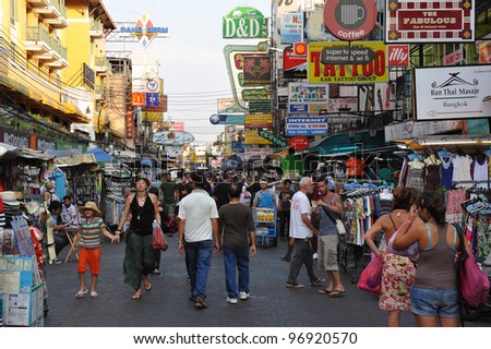 BANGKOK - FEB 25: Tourists walk along backpacker haven Kaosan Road as officials warn visas on arrival may be rolled back in the wake of recent terrorism incidents on Feb 25, 2012 in Bangkok, Thailand.