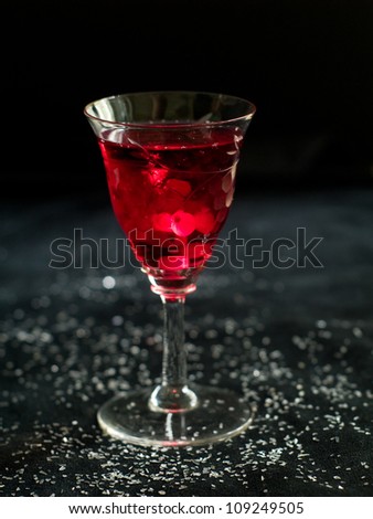 Hard liquor glass with cranberry, selective focus