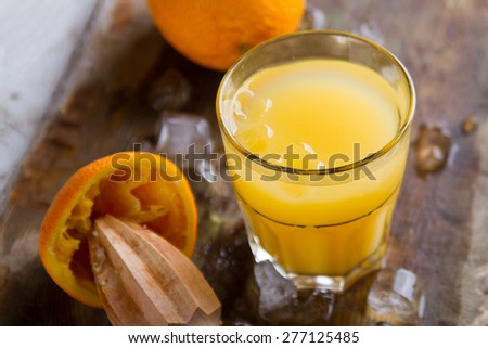 Fresh orange juice on wooden background, selective focus