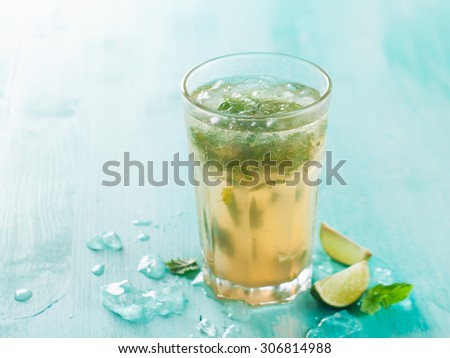 Mojito drink or lemonade with lime and mint, selective focus