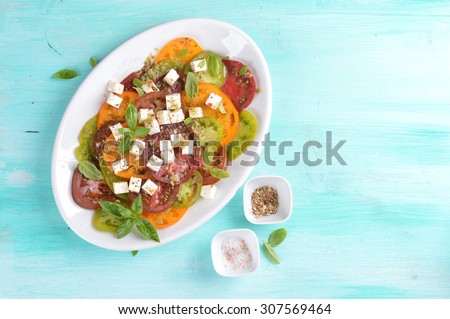 Salad with colorful tomatoes and cheese, selective focus