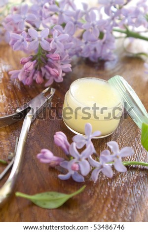 Massage cream for nail and manicure scissors. Lilac on background. Could be a generic toiletry.