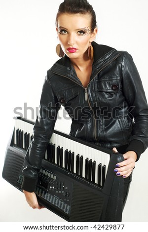punk rock fashion girl holding a piano keyboard