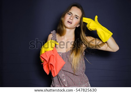 Tired stressed housewife after cleaning.Hand gesture of a gun.Angry woman