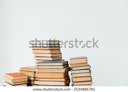 Similar – Image, Stock Photo Pile of books on a piece of furniture