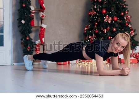 Similar – Image, Stock Photo Beautiful blonde woman doing home workout indoors. Woman practice yoga at home. Fit girl using workout tutorials for healthy active lifestyle. Woman using quarantine for home workouts.