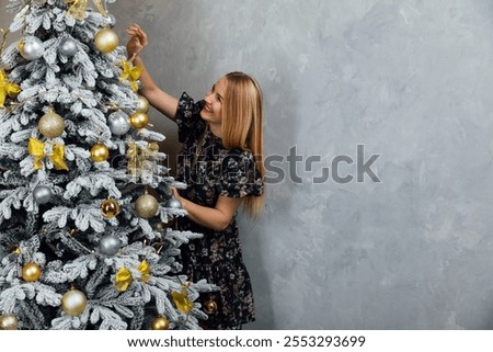 Similar – Image, Stock Photo Beautiful woman decorating hair with copper wreath against plank wall