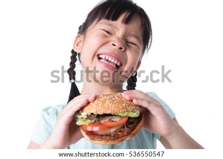 Similar – Foto Bild Hübsches Schulmädchen isst Hamburger und sitzt drinnen in einem Cafe. Glückliches Kind, das Junkfood in einem Restaurant isst. Seitenansicht