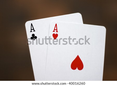 Pair of aces isolated on redbrown background.
